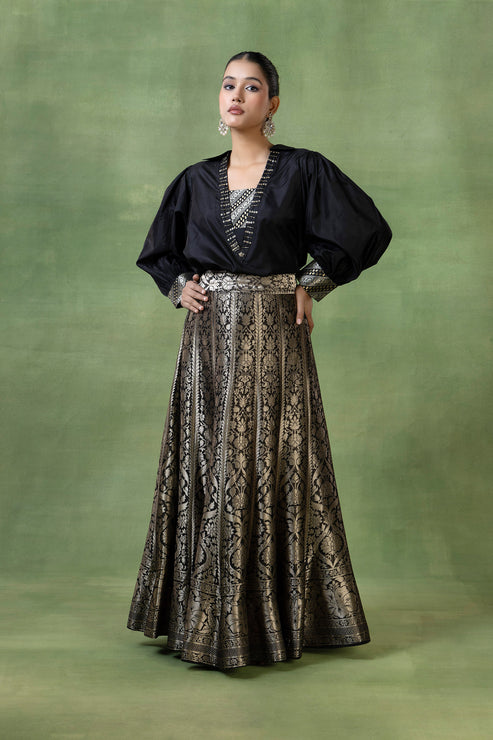 Woman in a gold brocade skirt with black turtleneck
